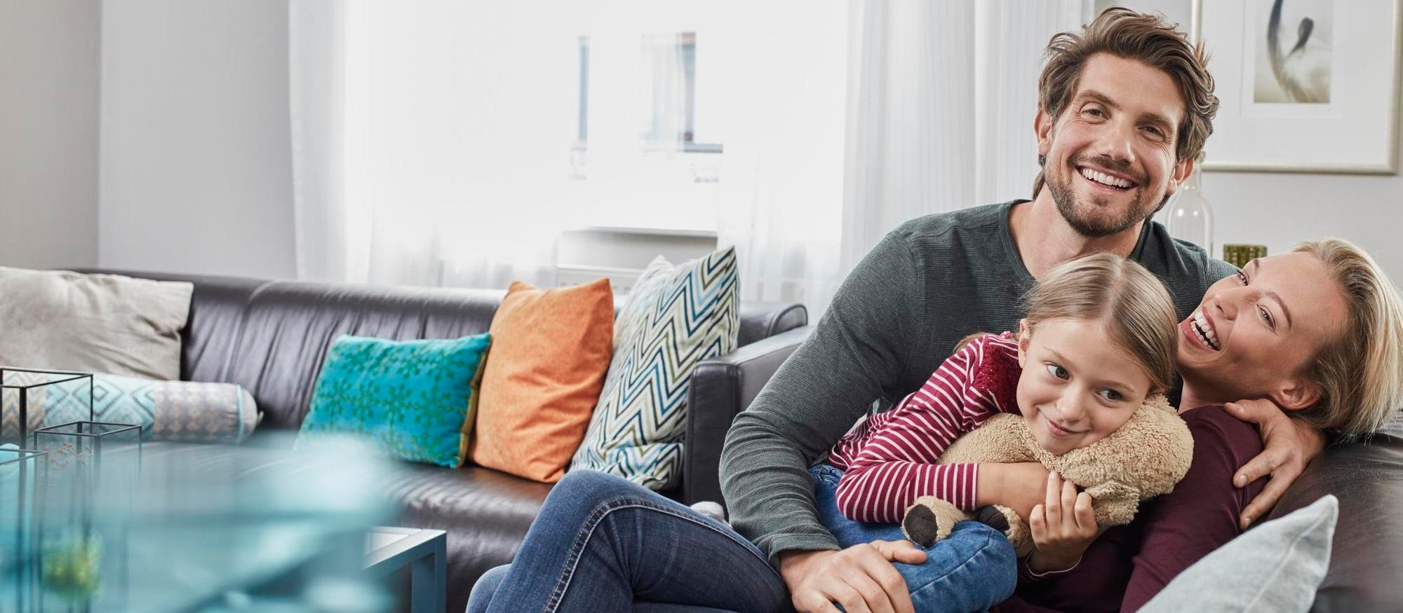 Happy family sitting on couch at home