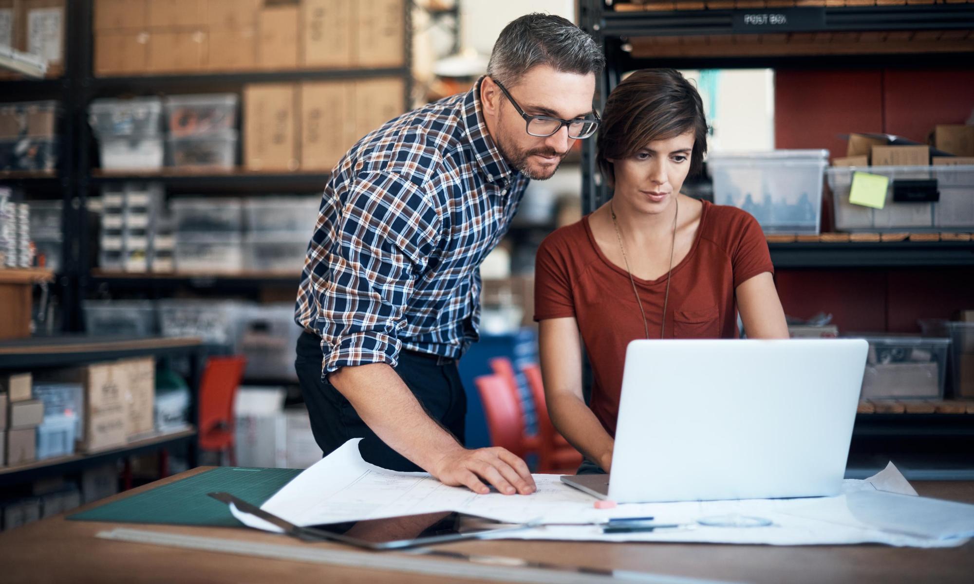 Man and woman in an industry using a laptop